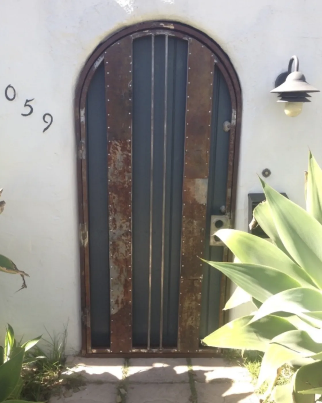 Arched steel entry door with vertical bars