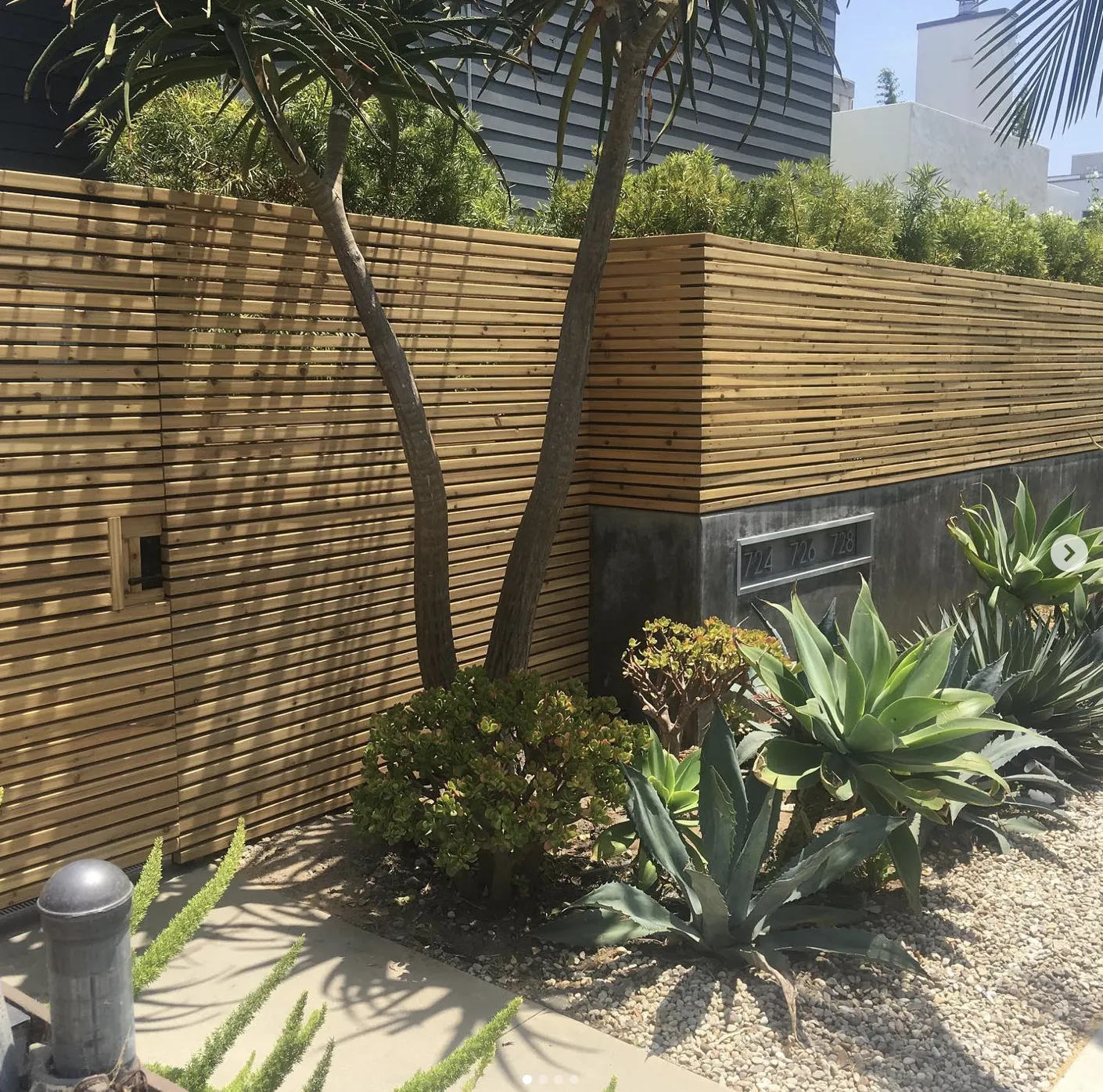 Horizontal slatted wood fence with garden